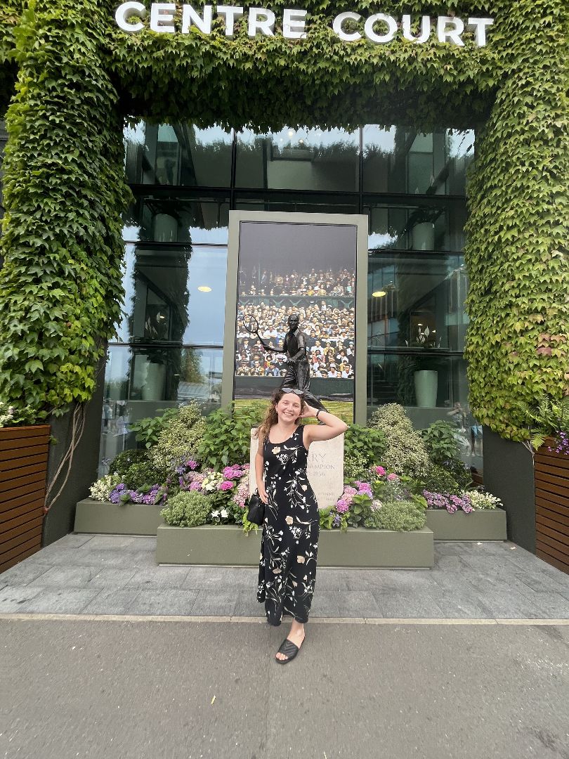 Ana standing in front of Centre Court sign at Wimbleton