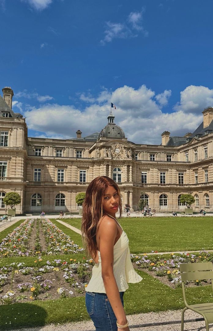 Mina posing in a garden in France