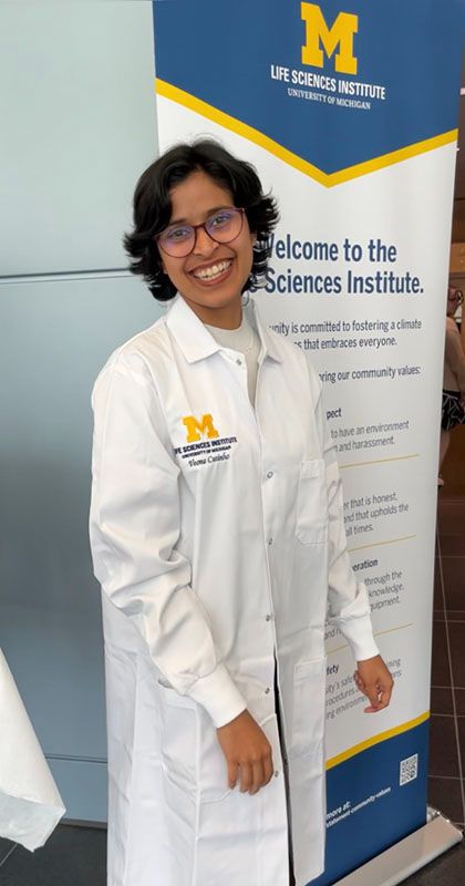 Veona Cutinho in a lab coat at the University of Michigan