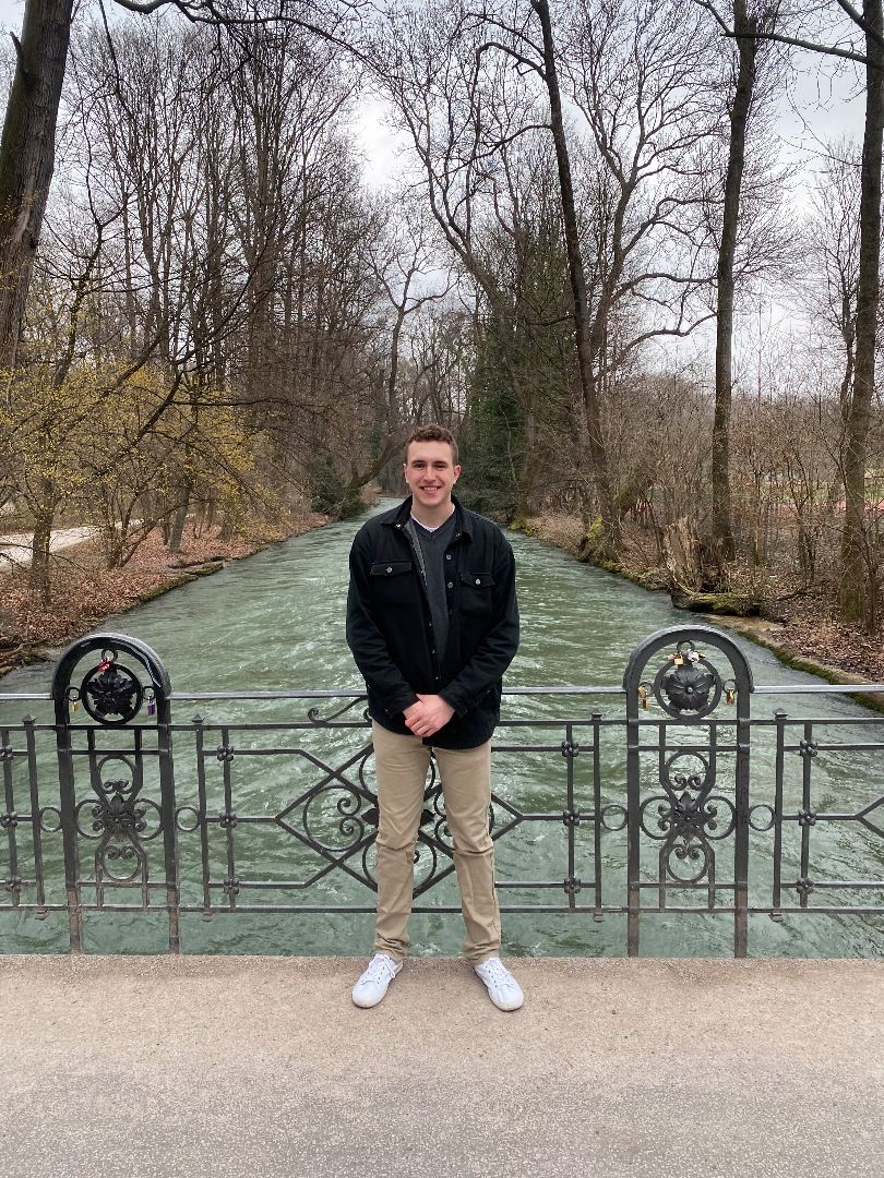 Tyler standing on a bridge in Munich Park