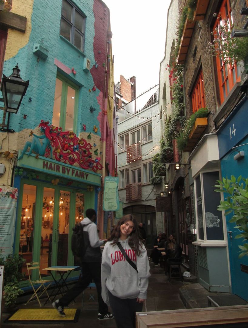 Jordyn standing in a narrow, colorful street in London