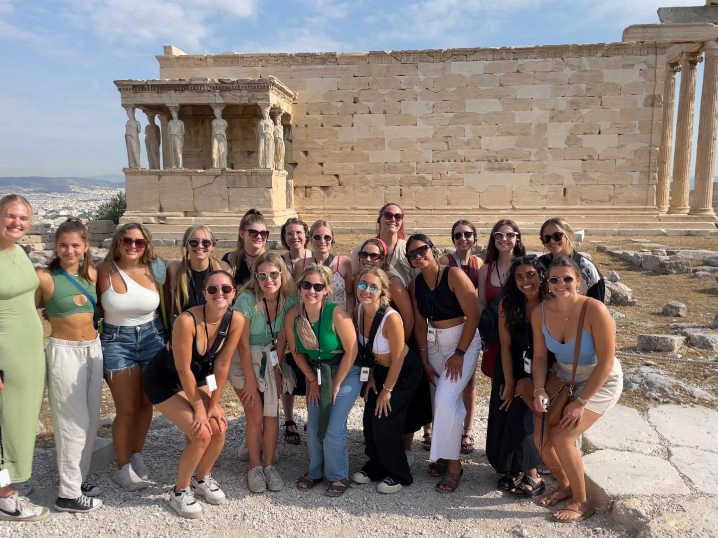 Group of students posing in front of Greek ruins