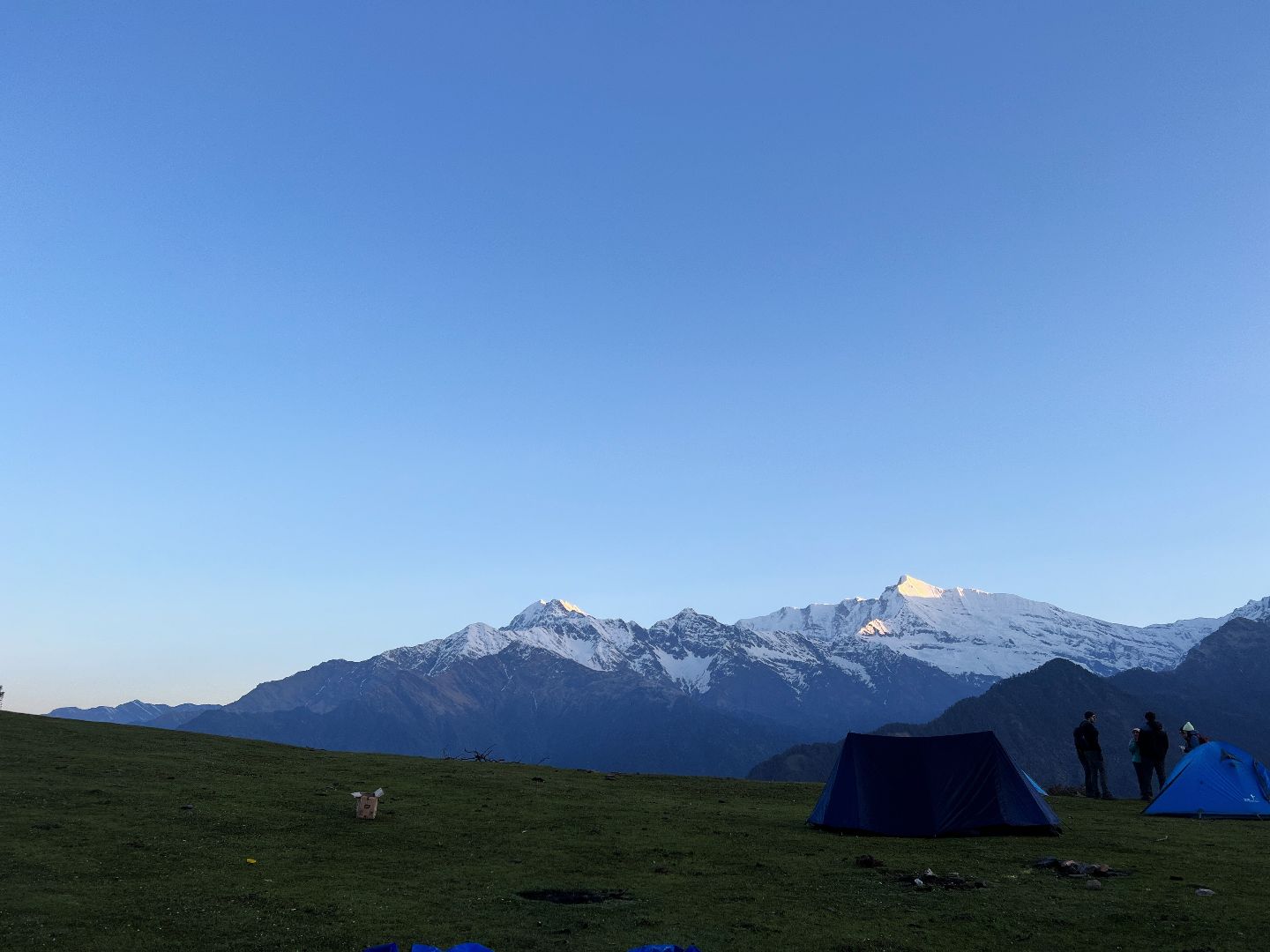Setting up tents with himalayas in background