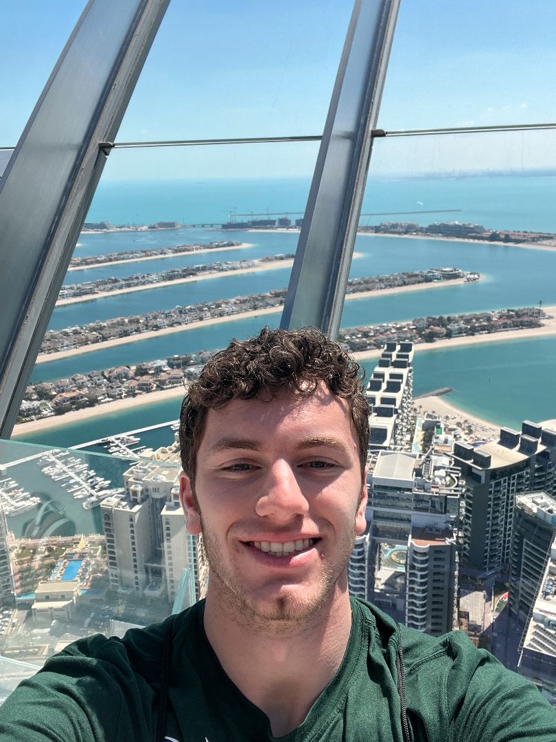 Blake taking a selfie atop a tall building in Dubai