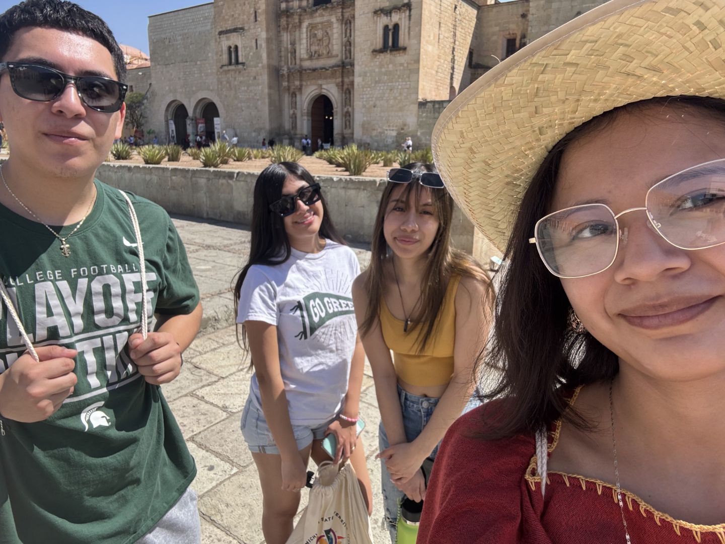 Janet posing with three friends on a street in Mexico