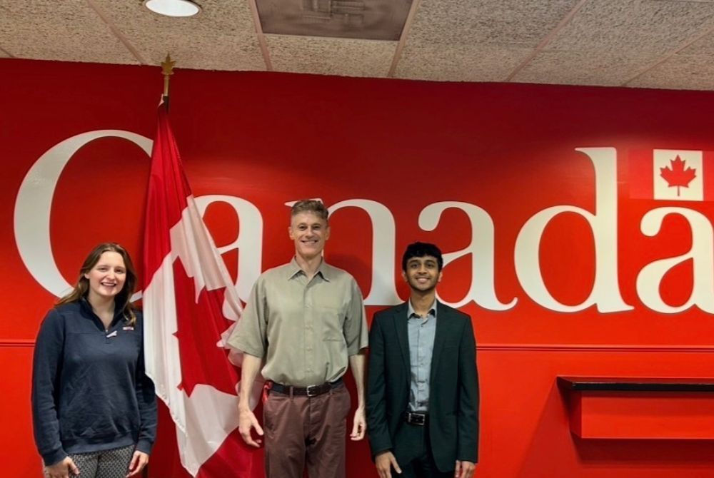 JMC students standing in front of a wall with Canada spelled out in large letters