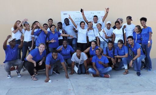 A group of employees and advocates with the DREAM Project pose exuberantly