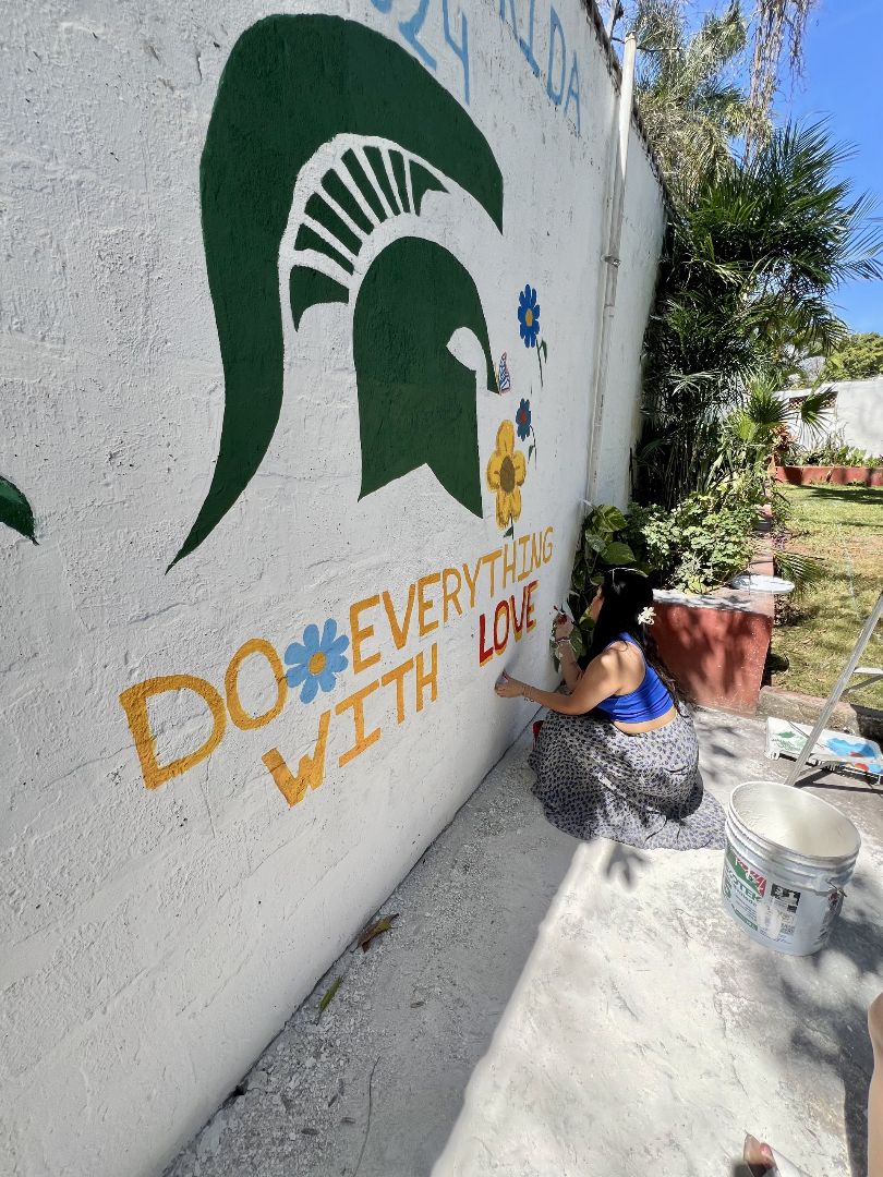 Selena painting an MSU mural in Mexico