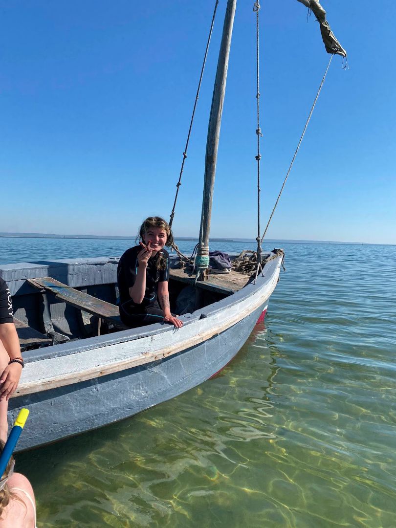 MaKenzie on a small boat in ocean