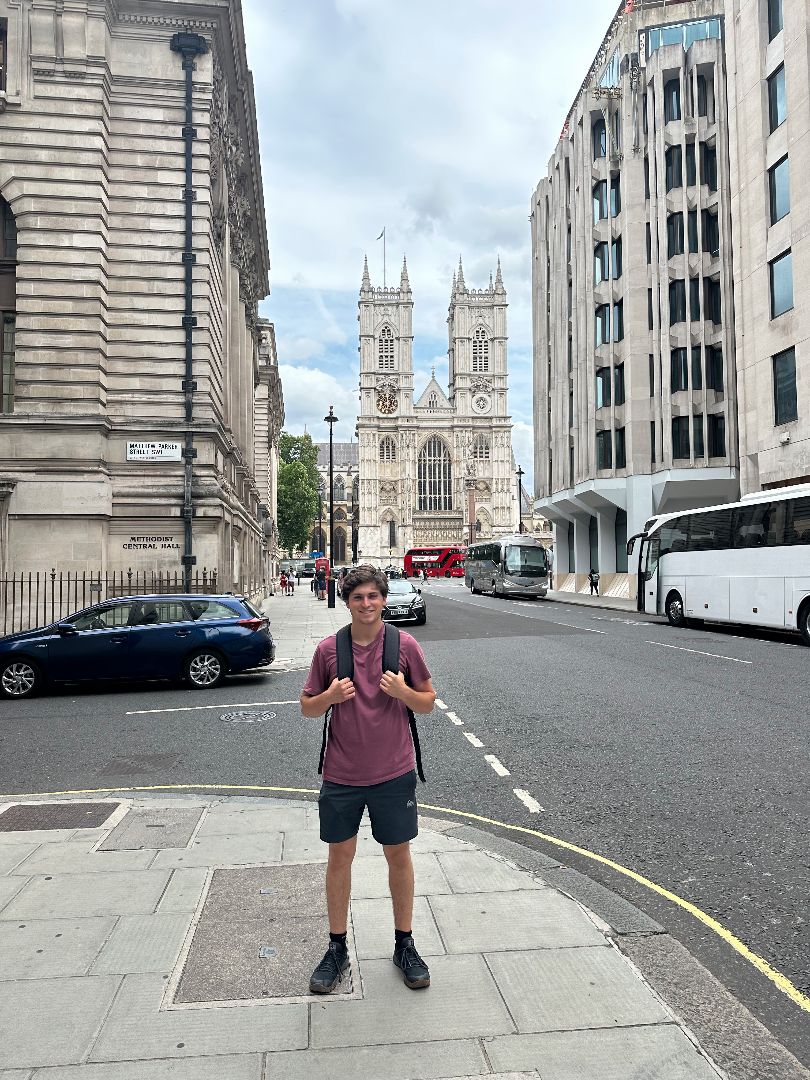 Keegan standing on street corner with Westminster Abby in the background
