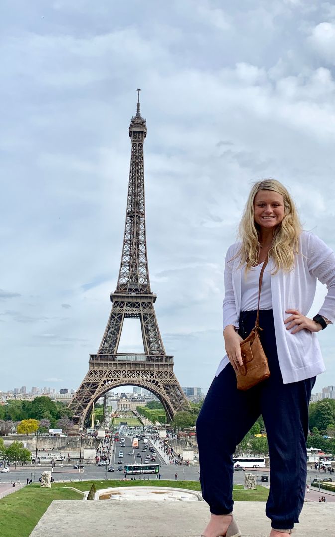 Emma in front of the Eiffel Tower in Paris, France.