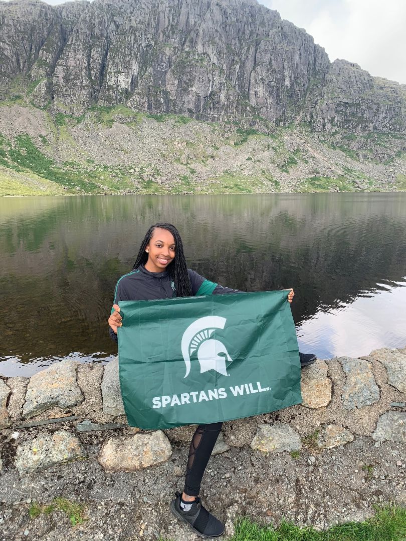 Deandrea with Spartan flag by lake in England