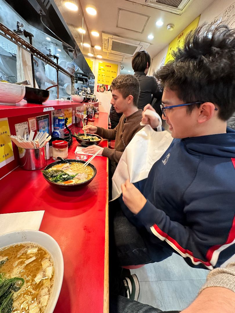 Students eating ramen at local restaraunt in Japan