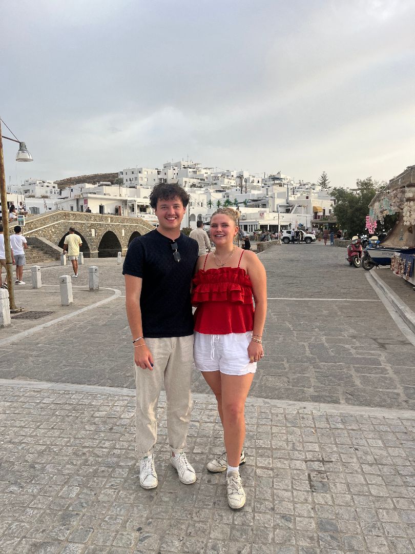 Brennan and friend posing for a photo on the streets of Greece