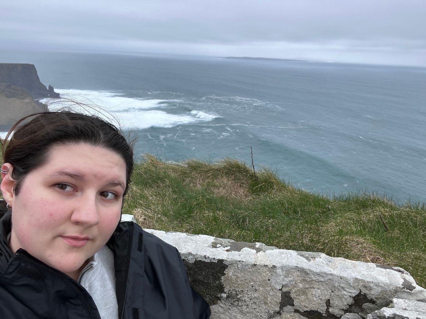 Faith taking a selfie on the Cliffs of Moher over looking the ocean