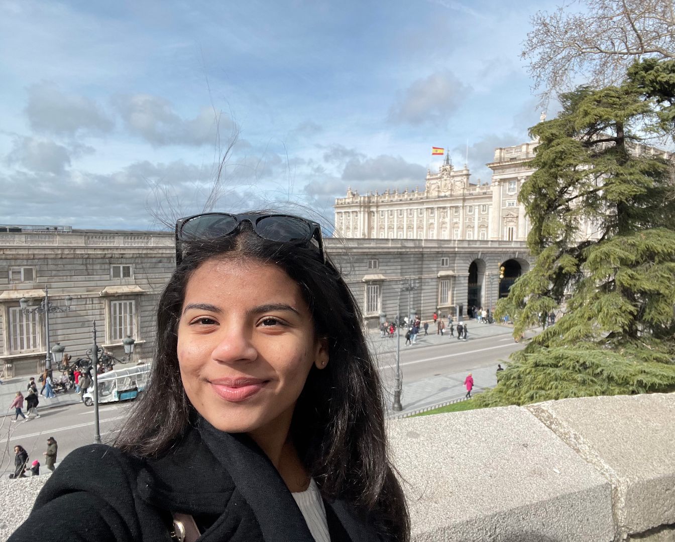 Emily taking a selfie in front of historical building in Madrid