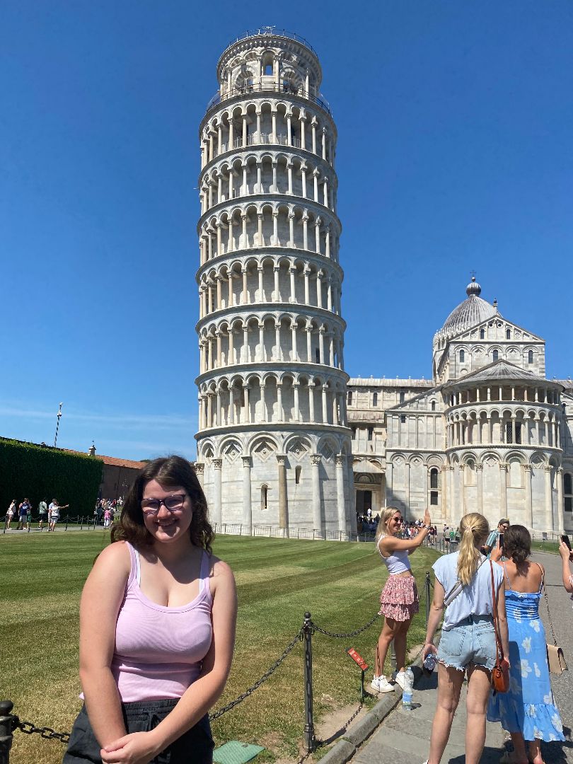 Hannah standing in front of the Leaning Tower of Pisa in Italy