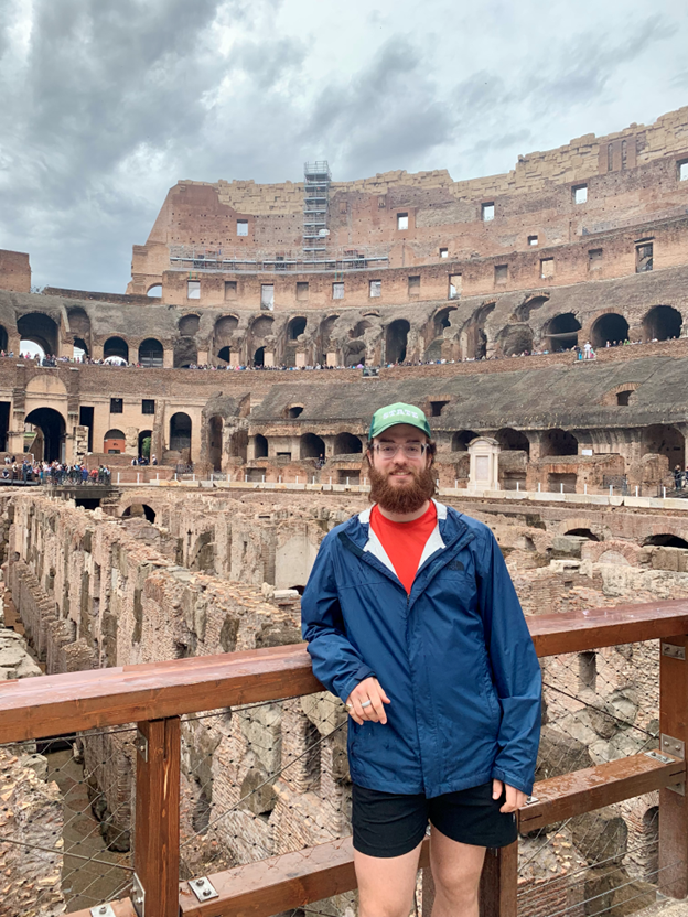 Ashton standing inside the Colesium in Rome
