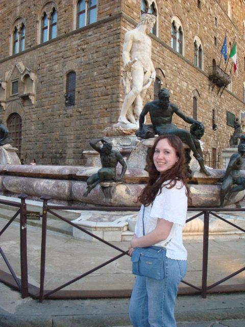 Oranna poses in front of a statue of David on the streets of Florence