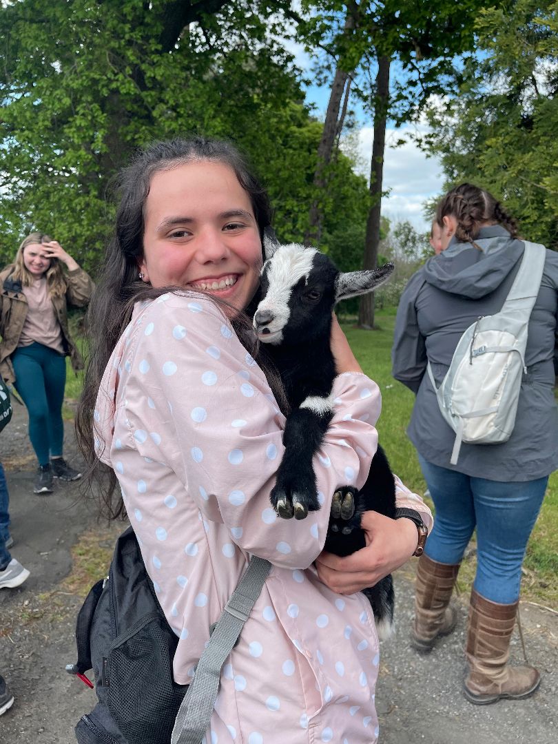 Kayleen holding a baby goat in Ireland