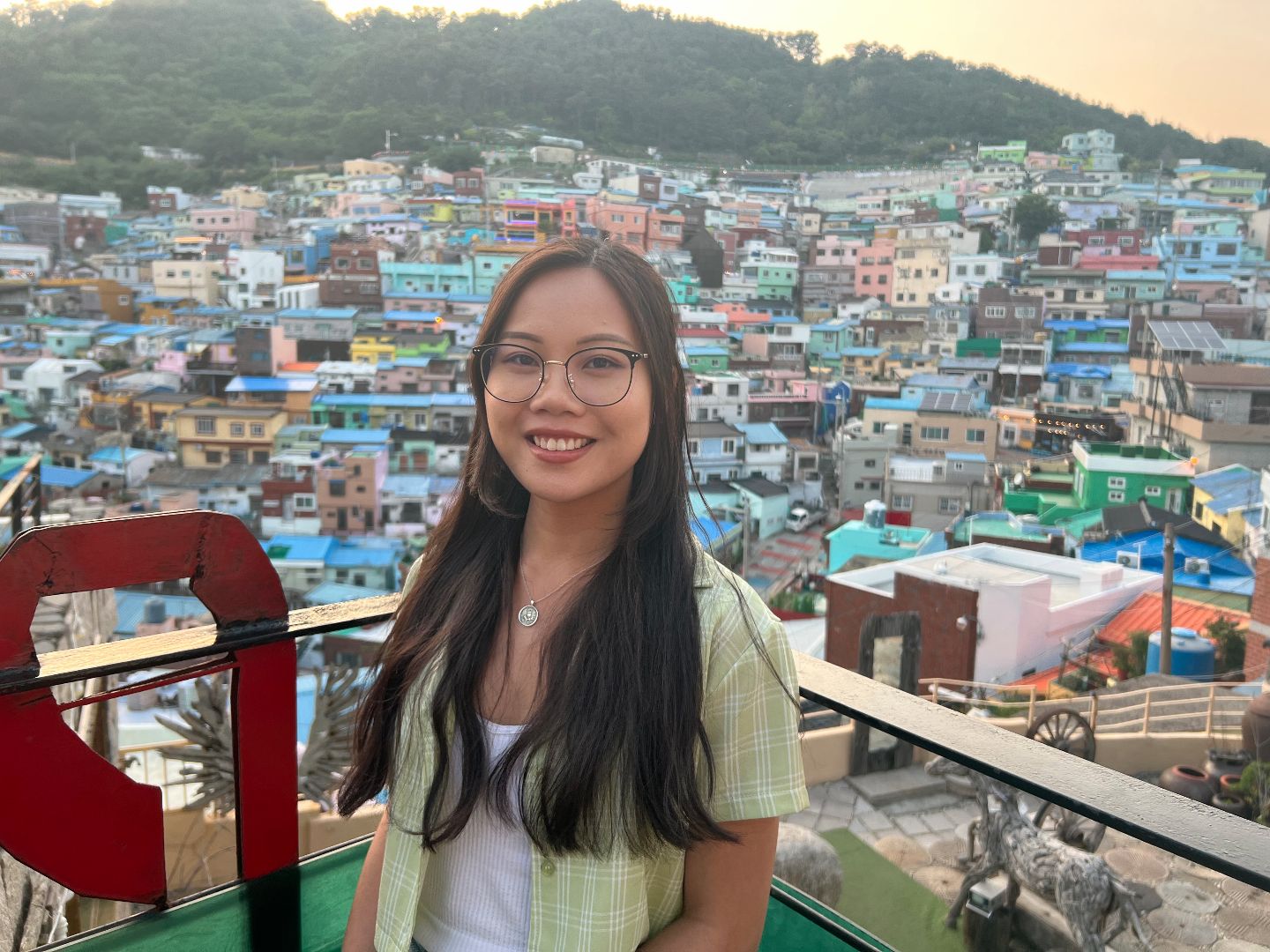 Sydney standing in front of a colorful village in S Korea