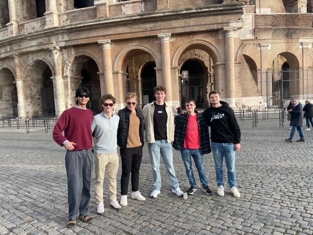 Andrew and friends pose in front of the Roman Collesium