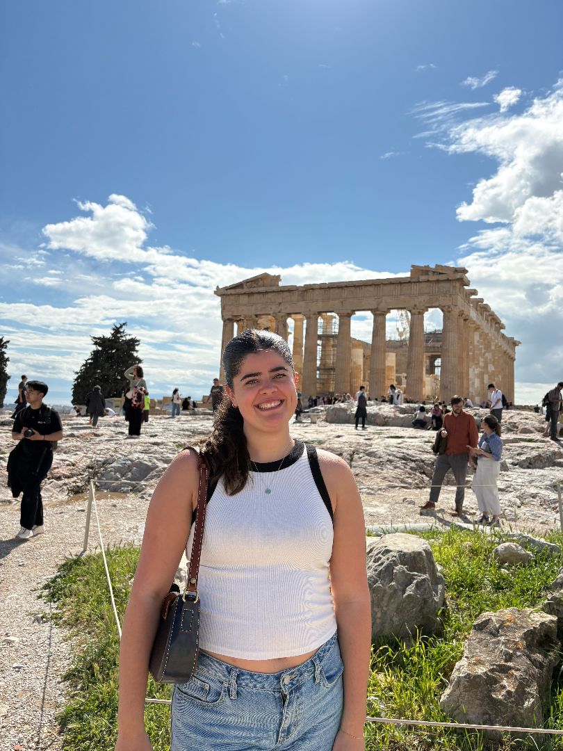 Lizzy standing in front of Greek ruins