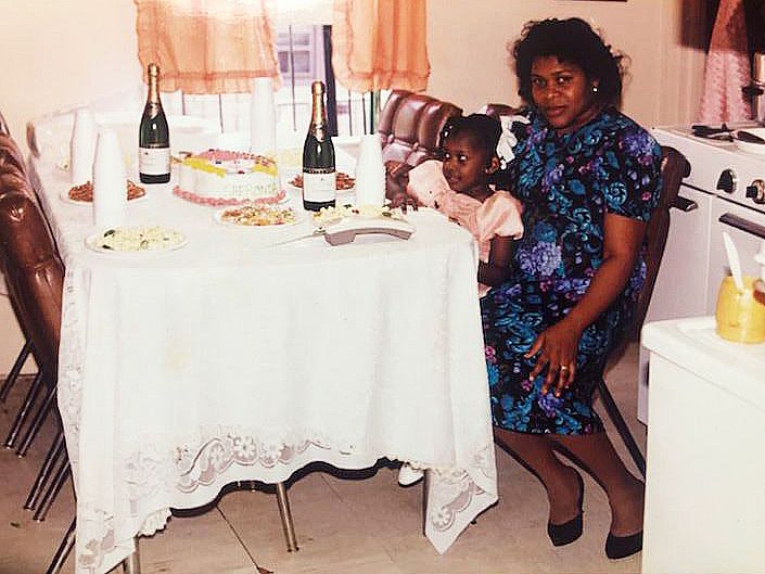 shewonda as a little girl sitting on chair with older woman who is her mother