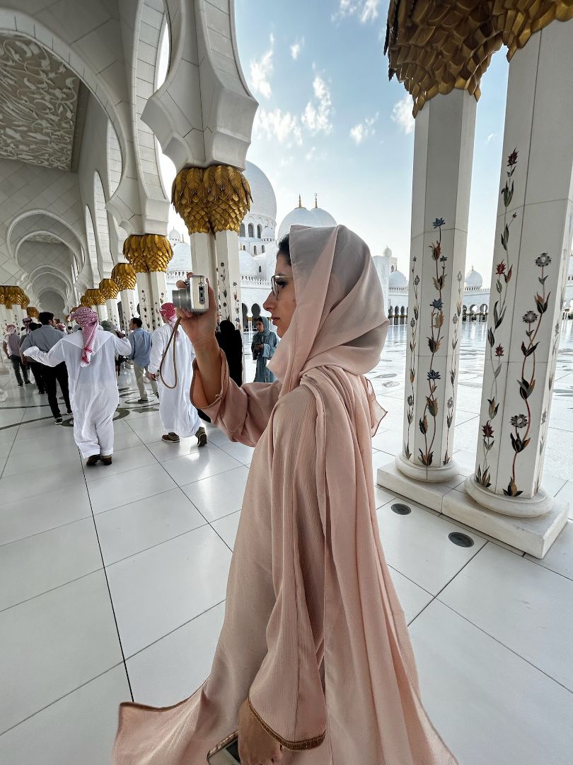 Malina taking a photo inside of an open air mosque