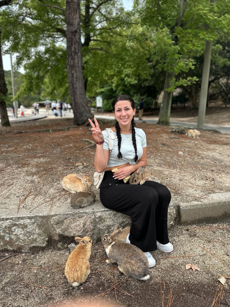 Marina sitting with bunnies in a park