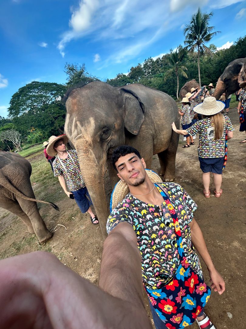 Hashed taking a selfie in front of an elephant in Thailand