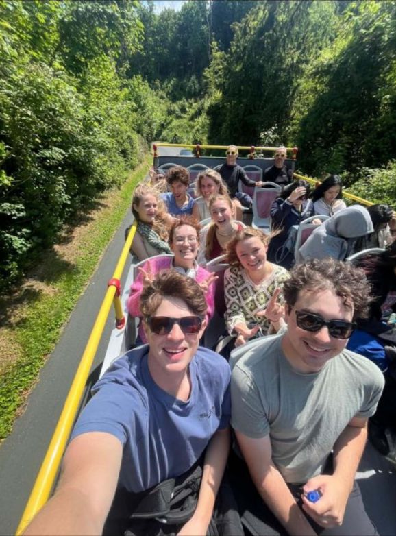 Cooper and friends taking a selfie while on open top sight seeing bus in the UK