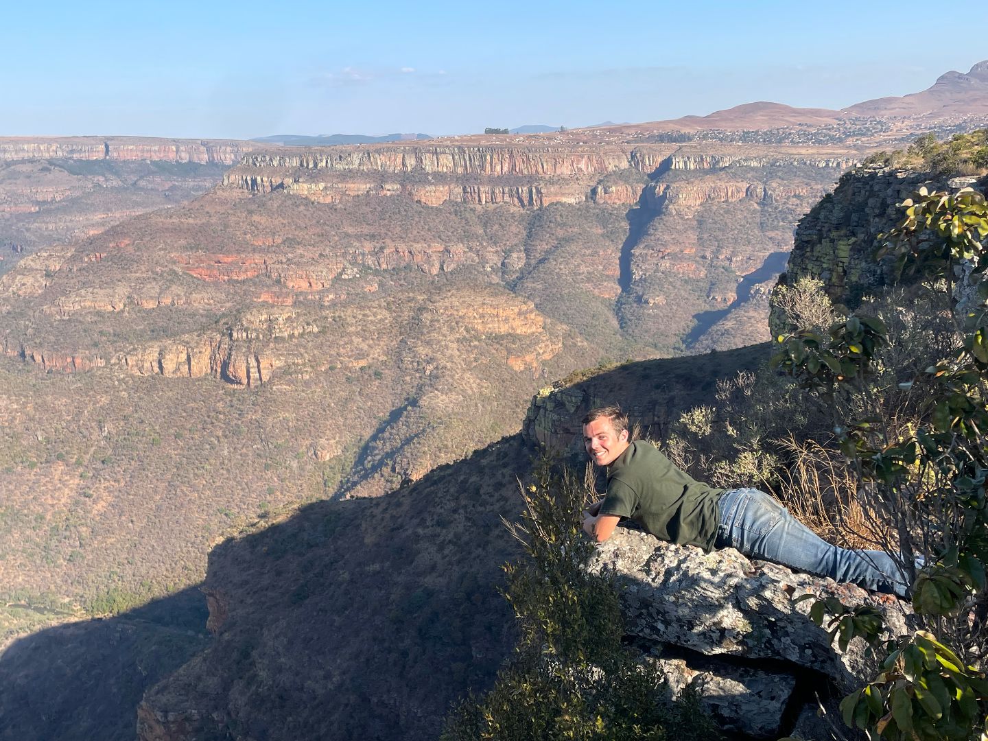 Giovanni laying on the ground looking over Tabletop Mountain