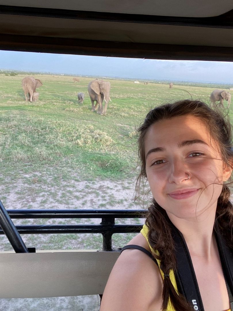 Rita taking selfie from jeep with elephants in the background