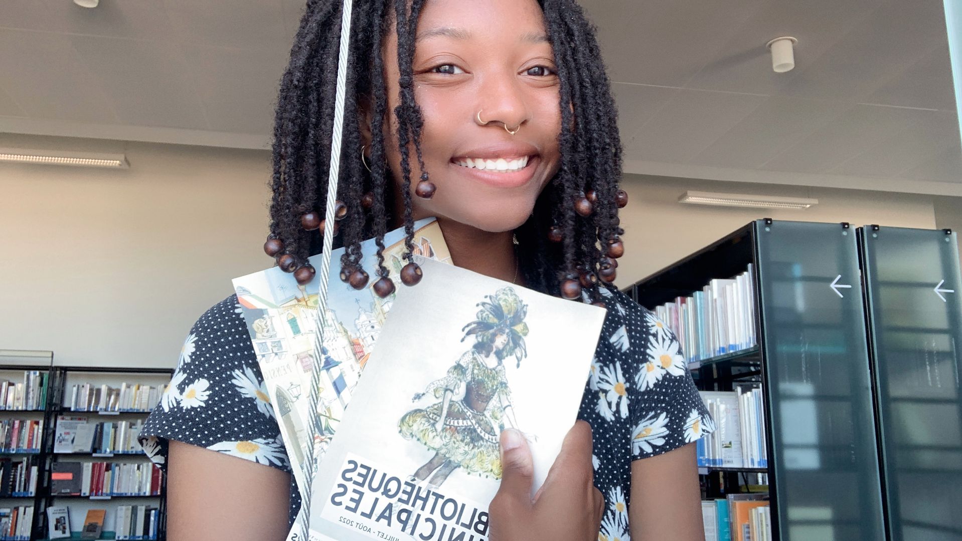 Destiny holding a french book in a library in France