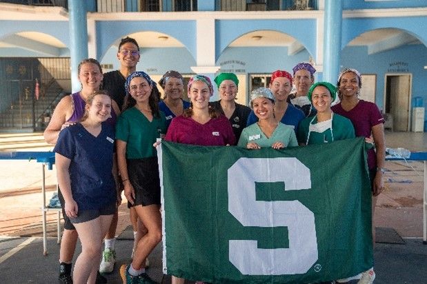 Group of students holding a Spartan flag in Mexico