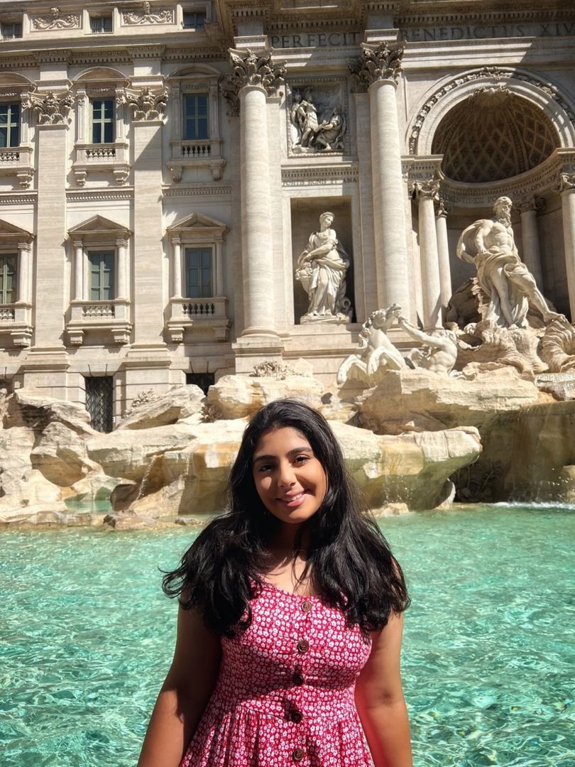 Zayna sitting in front ot Trevi Fountain in Rome Italy