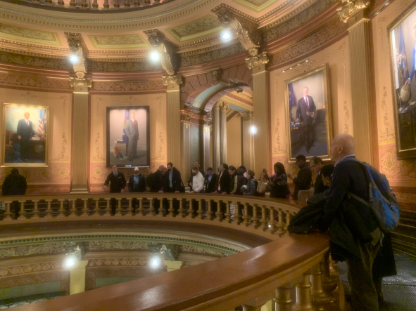 People stand on balcony in Michigan Capitol Rotunda