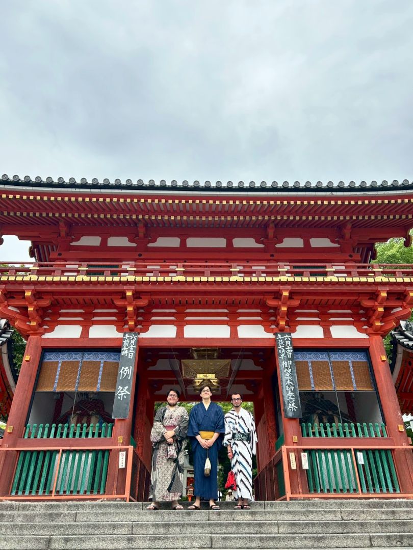 Miles and friends dressed in traditional Japanese clothing in front of a shrine