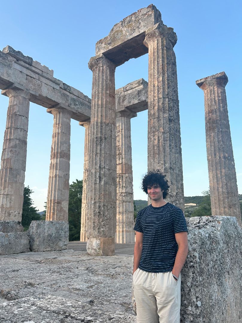 Gabe standing next to ancient columns in Greece