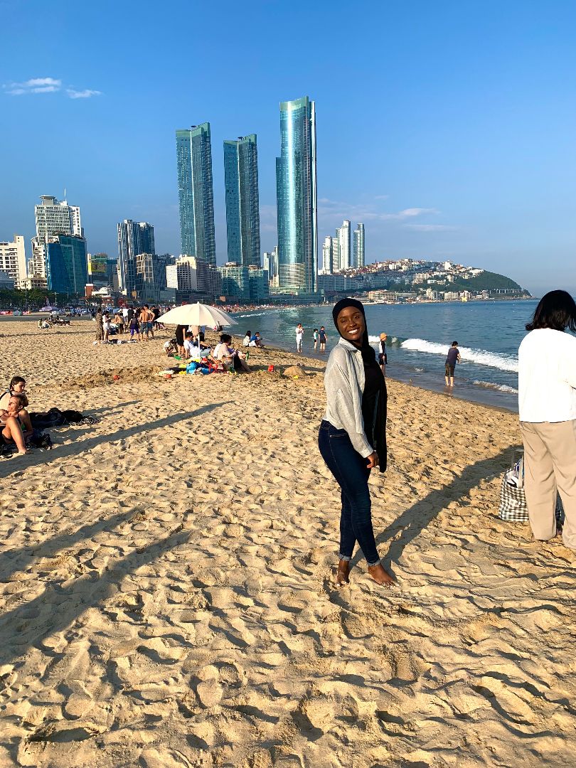 Mumina standing on beach in South Korea