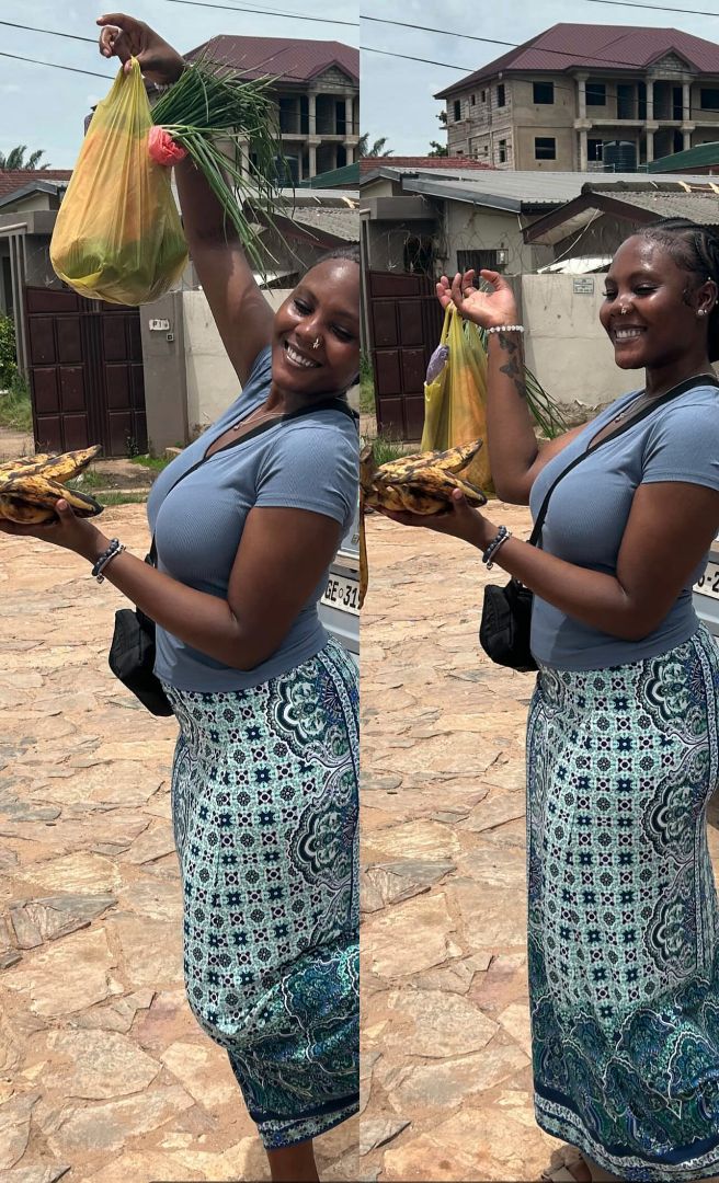 Nadio holding a bag of fruit on the streets of Ghana