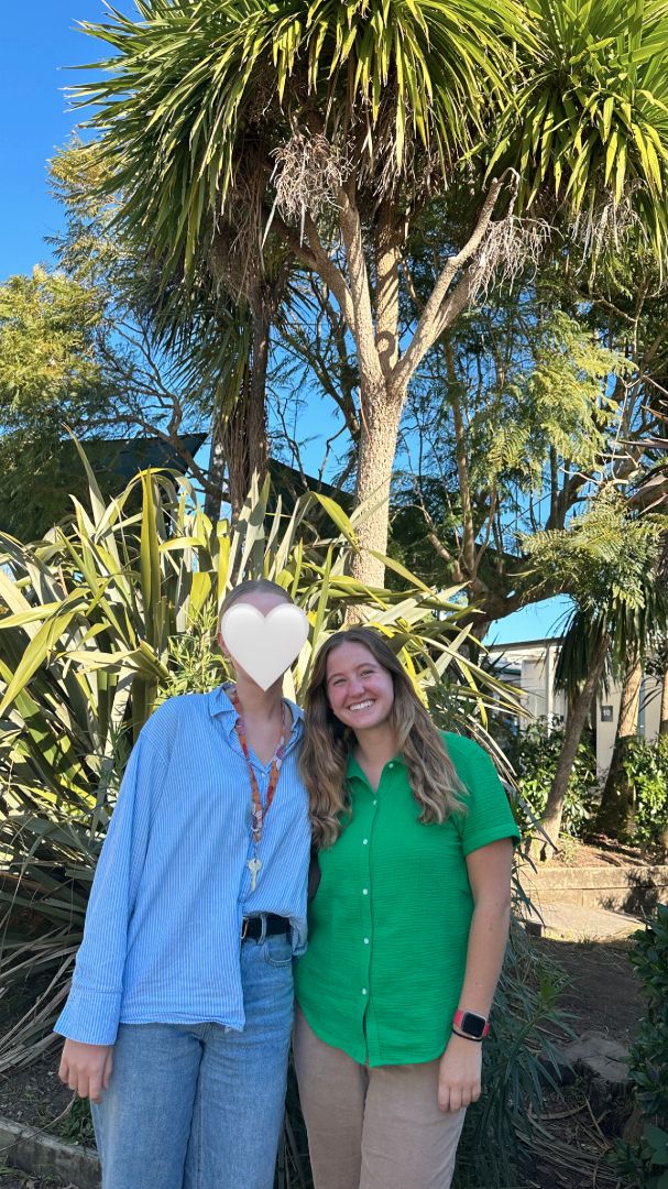 Lane standing with host mom under palm tree in New Zealand