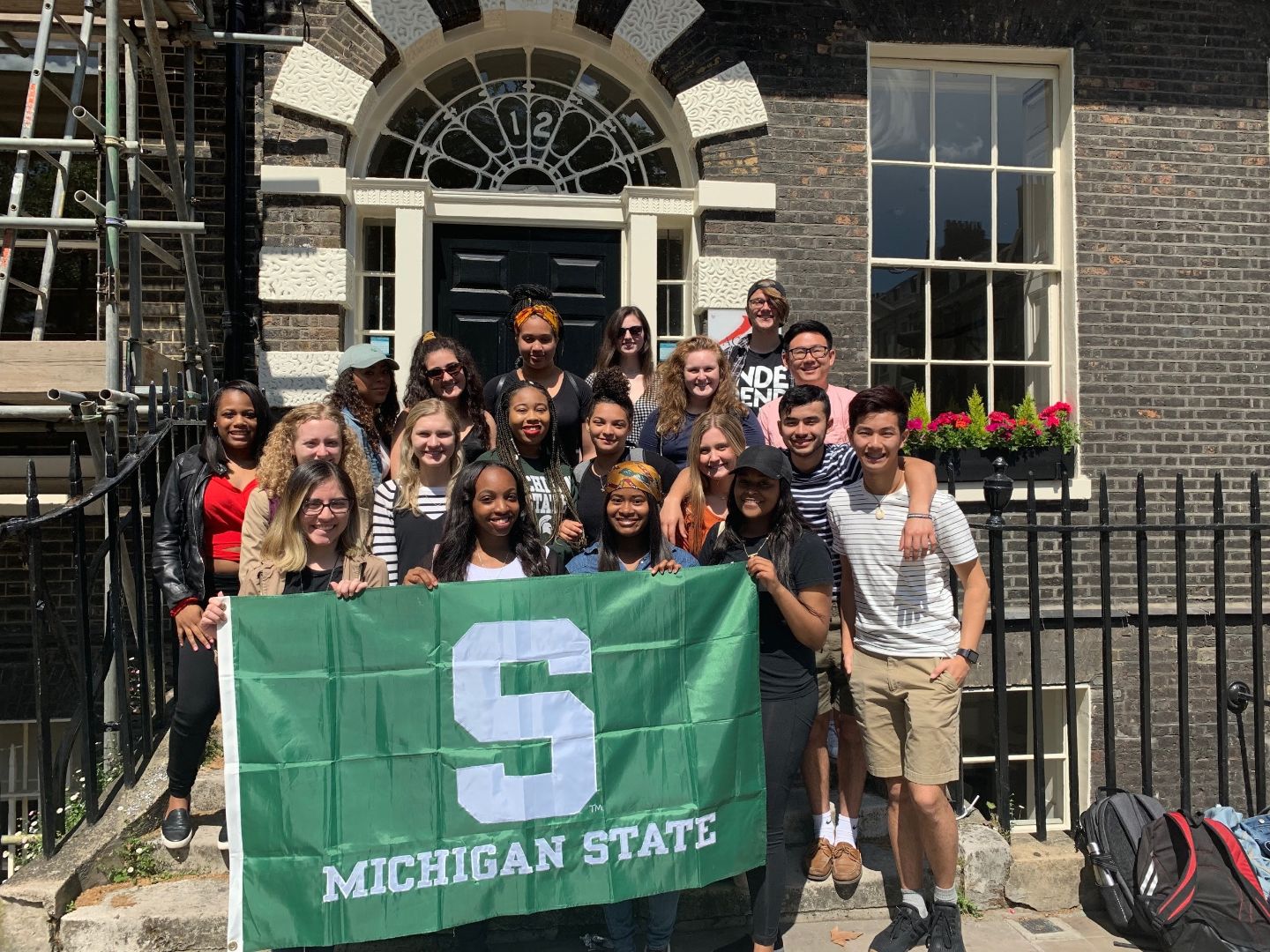 Group of students holding Spartan flag in London, England