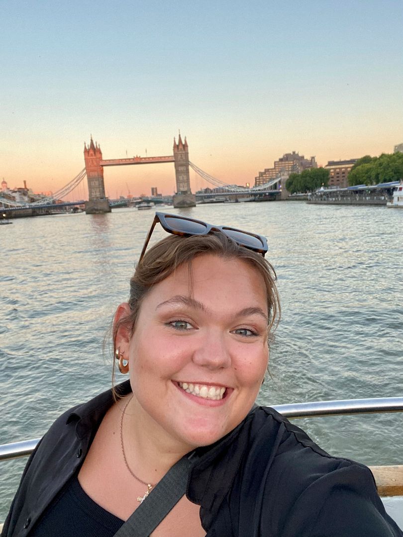 Isabel posing on the Thames with Tower Bridge in background in London