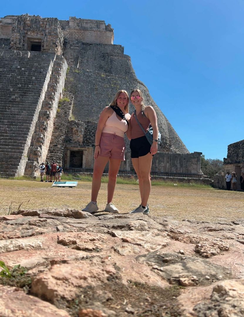 Macy and a friend standing in front of Mayan ruins