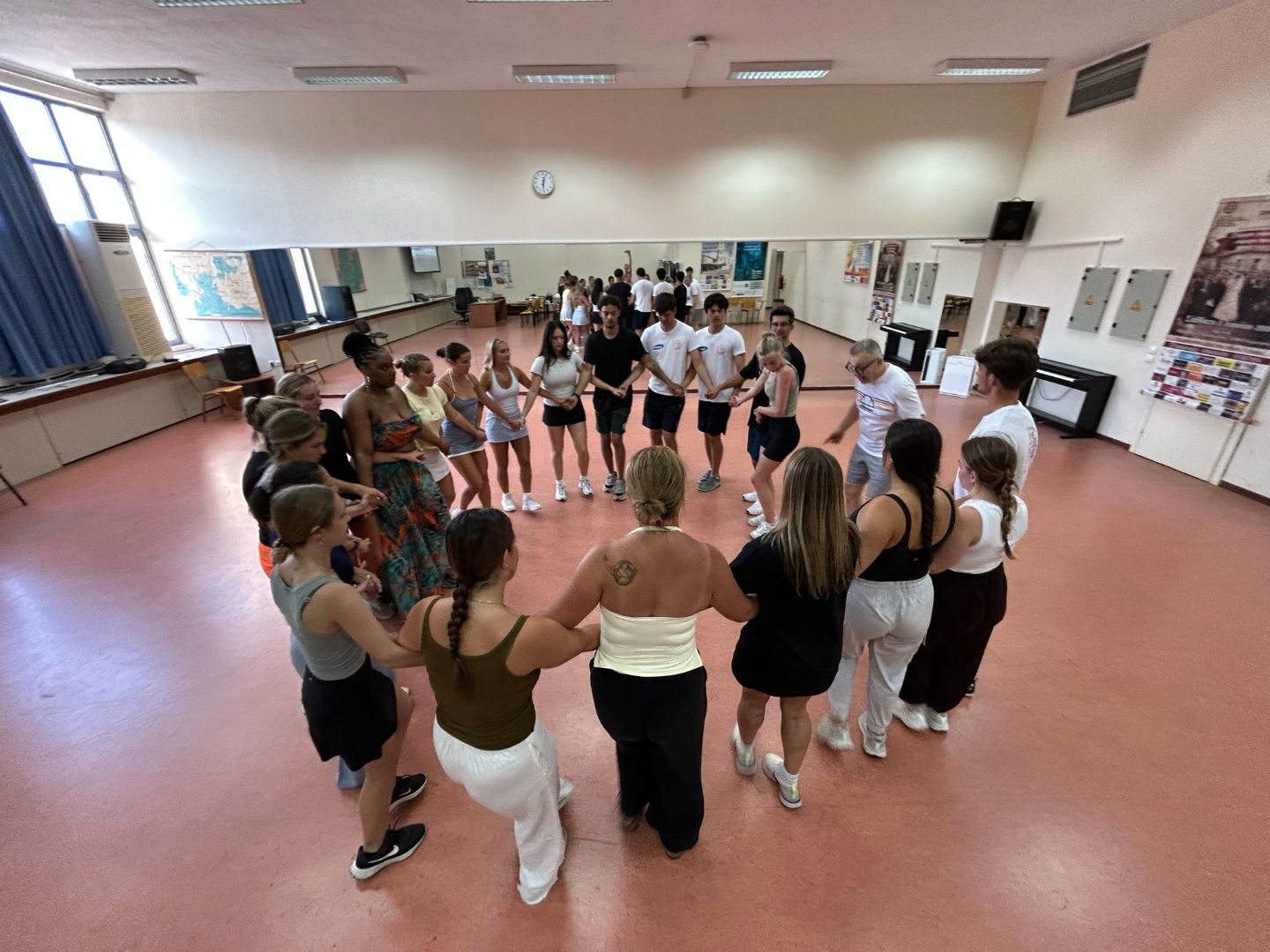 Group of students learning Greek dance in studio
