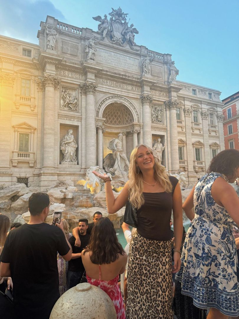 Christine standing in front of the Trevi Fountain in Rome