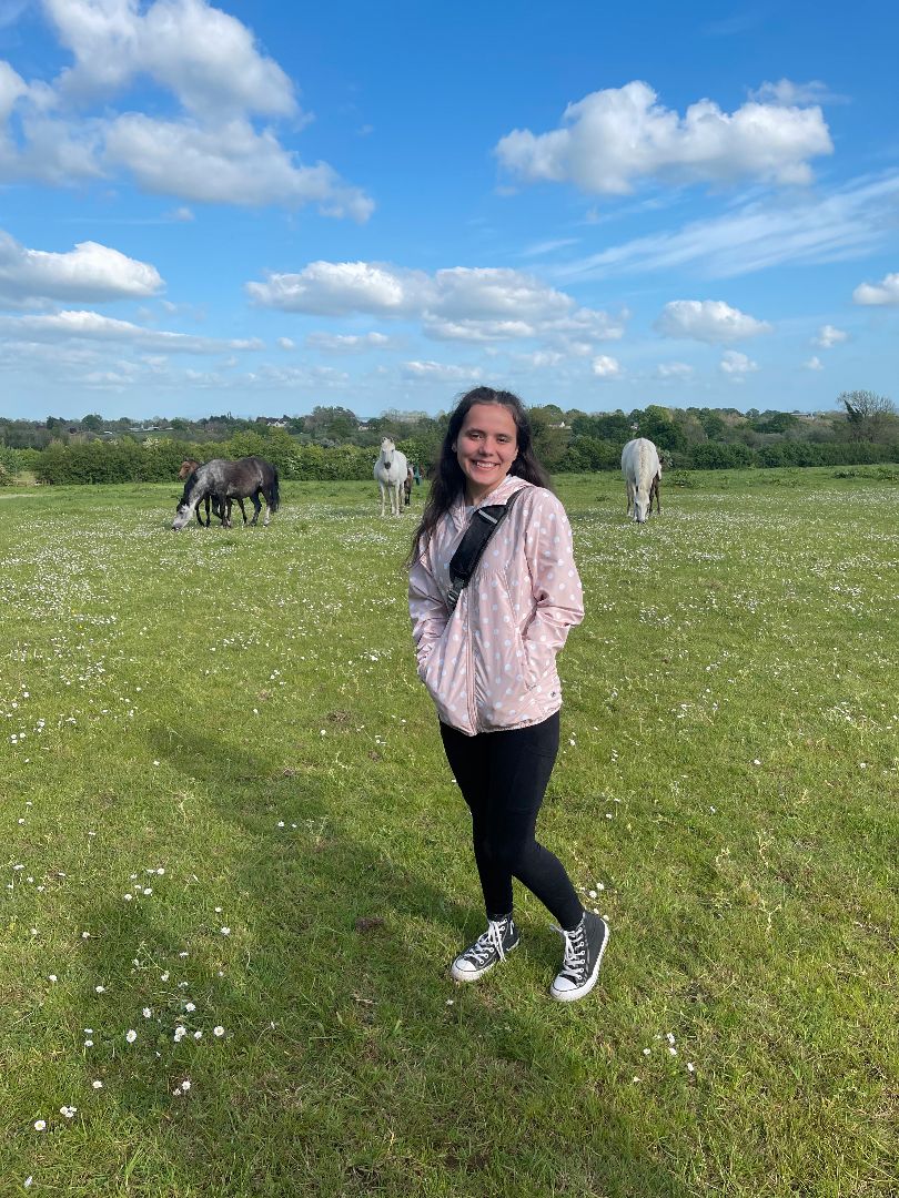 Kayleen in pasture with horses in Ireland