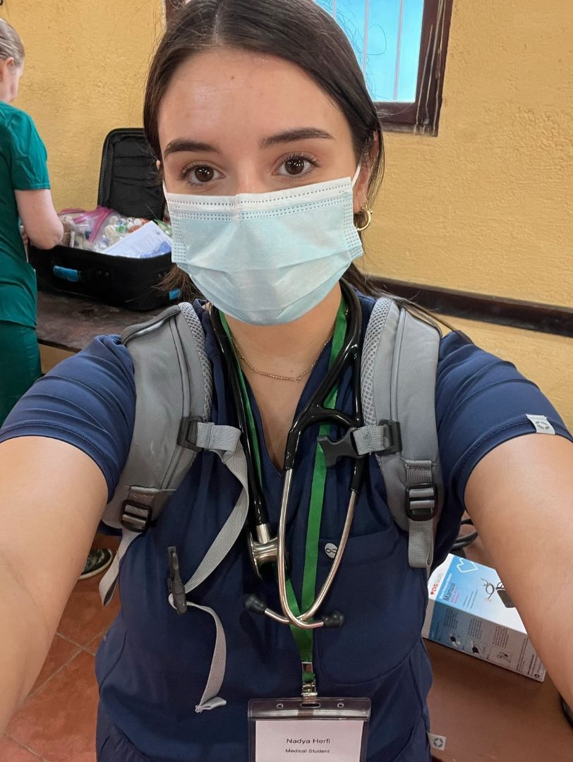 Nadya wearing a mask in scrubs at a clinic in Guatemala